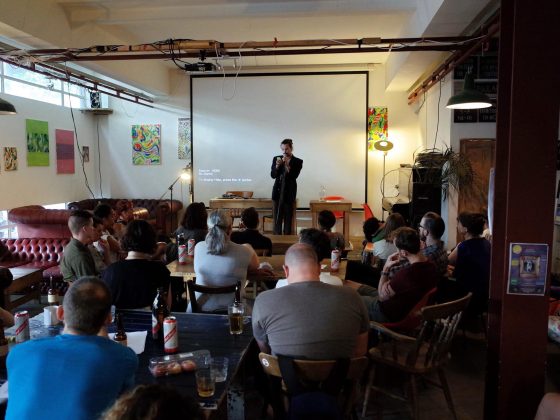 Andre Neely reading on stage